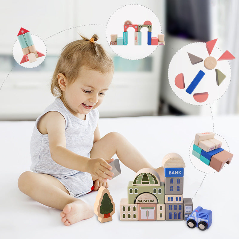 A toddler smiles while playing with colorful Large Montessori Wooden Building Blocks made from beech wood, creating a small town setup, with images of different buildings and vehicles floating around her by InvenToy.