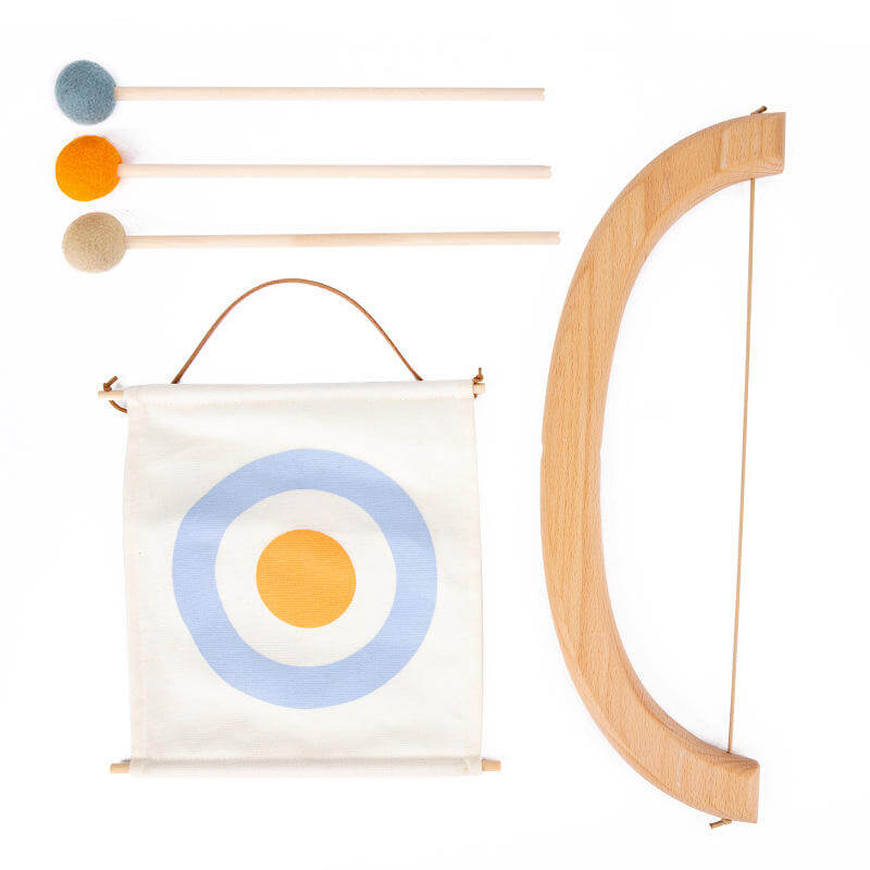 The InvenToy Montessori Bow and Arrow Set, a wooden toy bow and arrow set with three arrows featuring soft, colorful round tips (orange, yellow, and gray), is perfect for enhancing hand-eye coordination. The fabric target, with a blue outer ring, a light blue middle ring, and an orange bullseye, hangs from eco-friendly wood rods.
