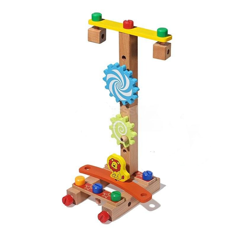 A colorful wooden InvenToy Montessori DIY Fun Chair featuring gears and pounding bench activities. The toy includes a vertical stand with blue and yellow gears and a horizontal base with pegs and a hammer.