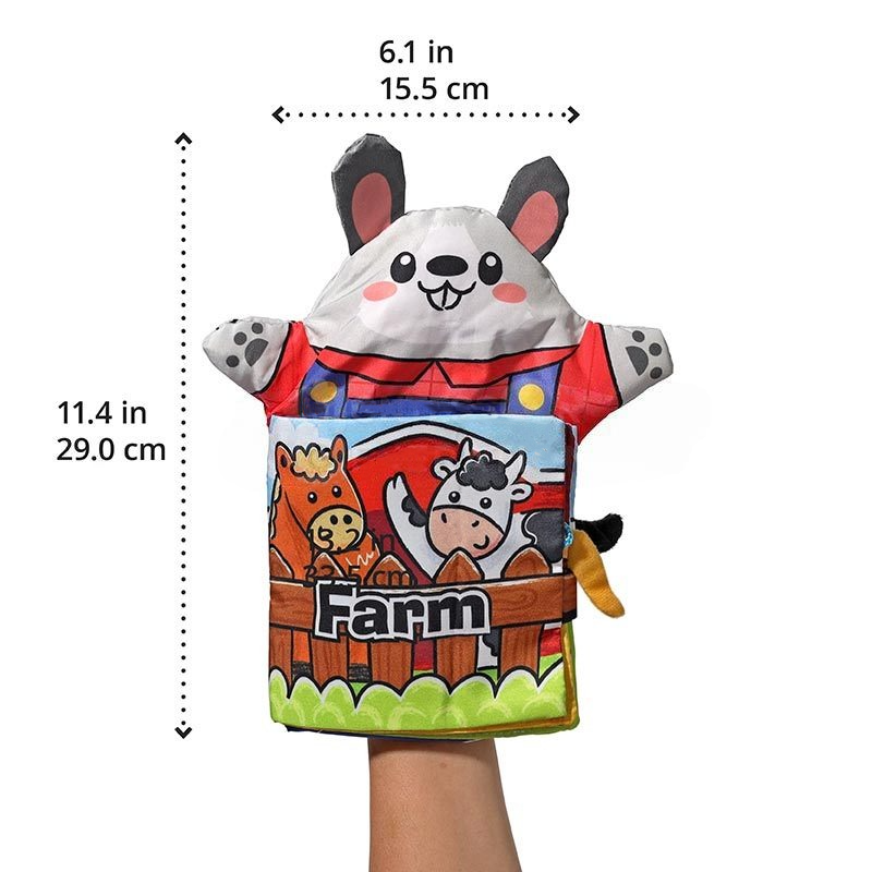 A colorful hand puppet shaped like a panda wearing overalls, featuring the InvenToy Montessori Baby Cloth Book farm scene with a cow and a horse, displayed on a human hand with measurements indicated on the sides.
