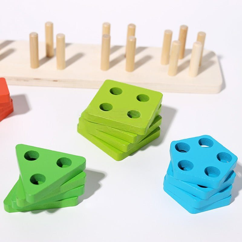 An educational InvenToy Montessori Building Blocks game featuring wooden pegs on a board, and stacks of green and blue triangular blocks with holes, set on a white surface.