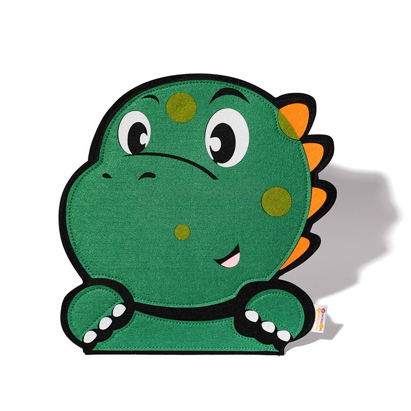 A colorful, cartoon-style green dinosaur Montessori plush toy (Montessori Dino Busy Board) with a friendly expression, sitting upright against a white background. The plush has orange spikes and yellow spots.