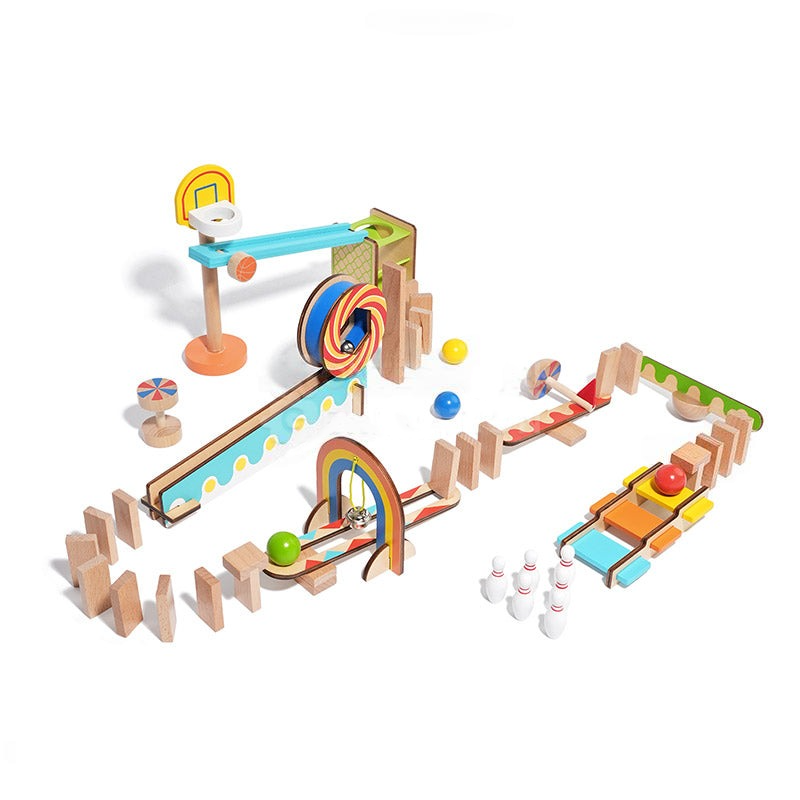 A colorful wooden InvenToy Montessori Domino Run set featuring tracks, a windmill, cars, pins, and several balls on a white background, arranged in an interactive play setup.