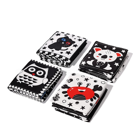 Four stacks of square, monochrome InvenToy Montessori Newborn Contrast Books with colorful animal illustrations (bear, panda, owl, crab) on a white background. Each book has a patterned border and