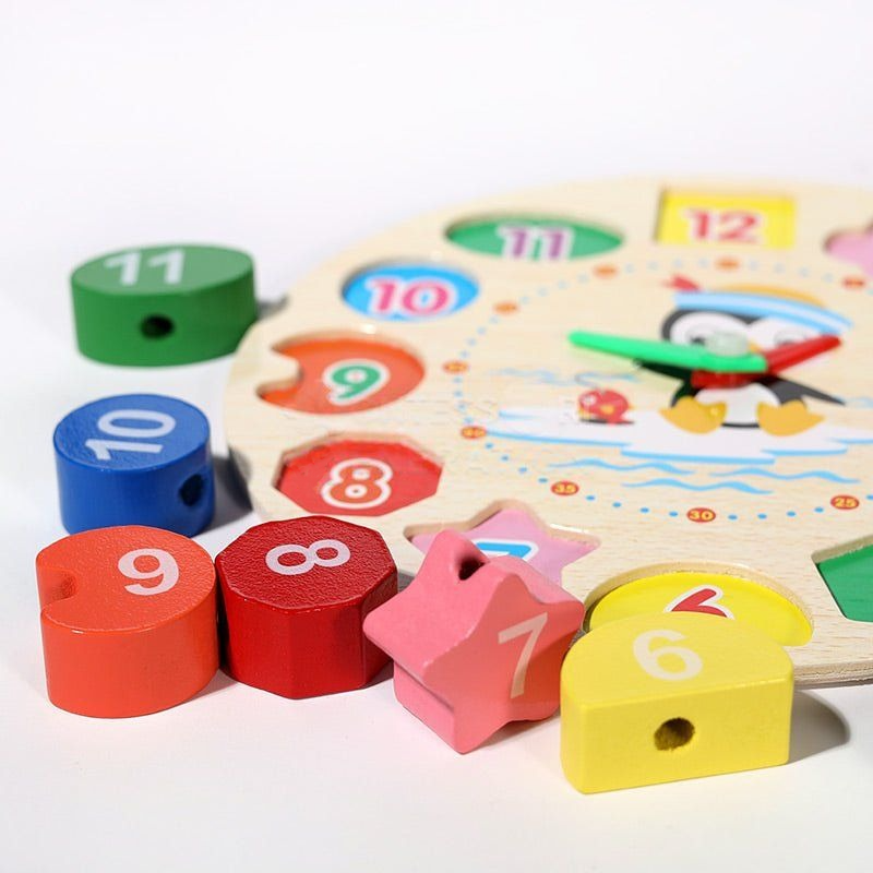 A colorful wooden Montessori Penguin's Clock educational toy featuring shapes numbered 1 through 12, designed for teaching numbers and shapes to children, displayed against a white background.