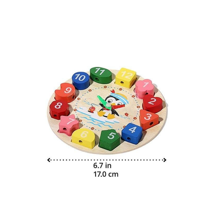 A colorful wooden clock puzzle for children, featuring numbered pieces from 1 to 12 arranged in a circle around a smiling cartoon character. This InvenToy's Montessori Penguin's Clock toy has dimensions indicated below.