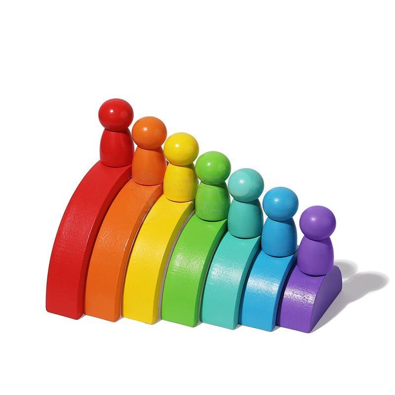 A colorful InvenToy Montessori Rainbow wooden toy consisting of nested arcs in a rainbow spectrum and small matching spheres on top, arranged from red to purple, set against a plain white background.