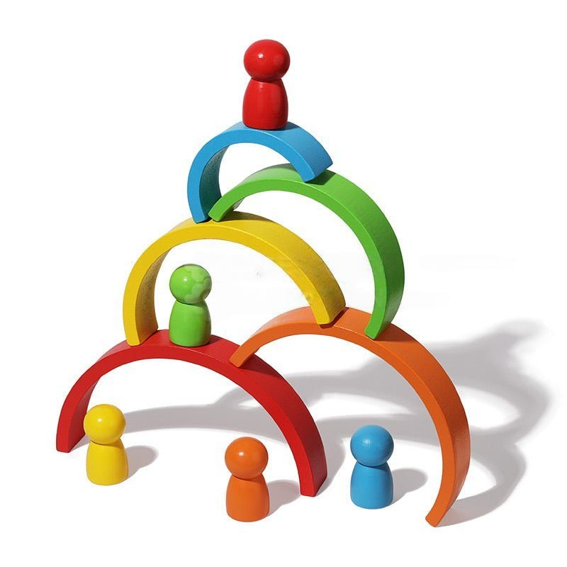 A colorful wooden InvenToy Montessori Rainbow toy consisting of stacking rainbow arches in red, orange, yellow, green, and blue, with matching peg dolls on a white background.