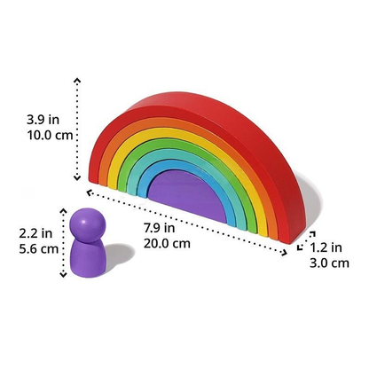 A colorful InvenToy Montessori Rainbow with seven nesting arches, each in a different color, and a small purple figurine beside it, with measurements displayed.