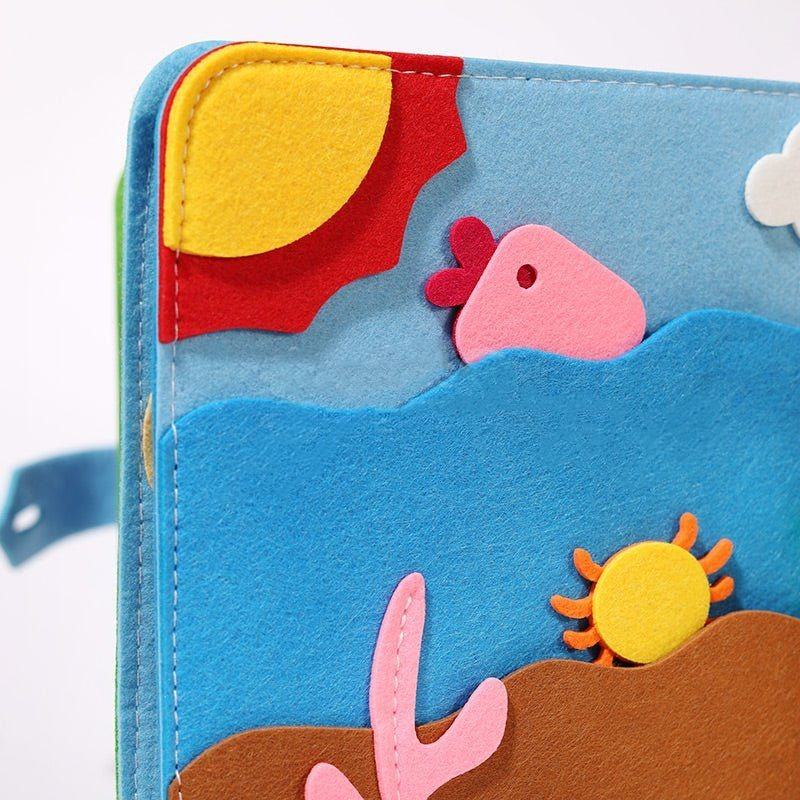 Colorful felt wallet decorated with a playful underwater scene featuring a fish, waves, a sun, and other marine elements in vibrant primary colors, ideal for InvenToy Montessori Story Book-inspired play.