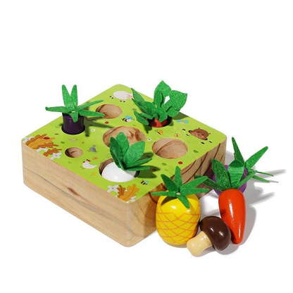 A wooden InvenToy Montessori Vegetable Set featuring a garden theme with slots for various colorful vegetable-shaped pieces like carrots, aubergines, and corn, each with green felt leaves, on a white background.