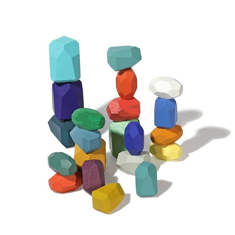 Colorful InvenToy Montessori Wooden Stones (21 Pieces) in various geometric shapes stacked loosely against a white background, casting soft shadows.