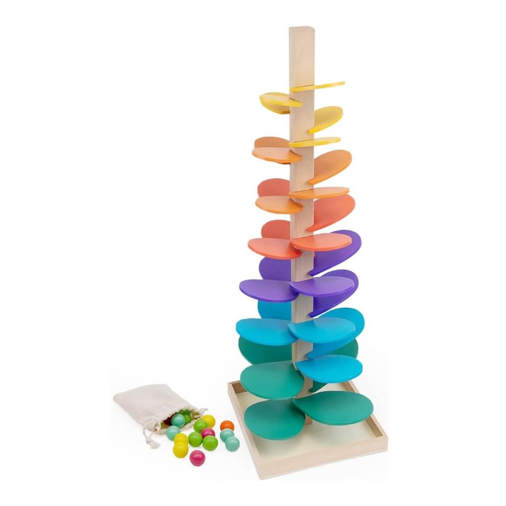Colorful wooden spiral tower Montessori Rainbow Tree toy by InvenToy with a set of multi-colored balls and a bag on a white background. The toy features a central wooden pole with curved arms for the balls to roll down.