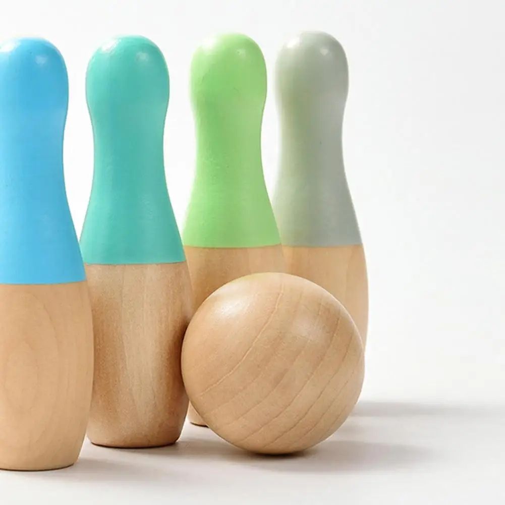 Four InvenToy Montessori Bowling Sets wooden bowling pins in blue, green, and gray tops, with a natural wooden bowling ball in front, on a white background.